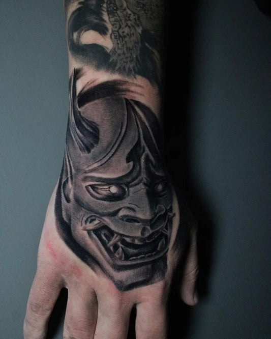 Medium Black and Grey Oni Mask on Men Wrist Tattoo by @jimiderosa