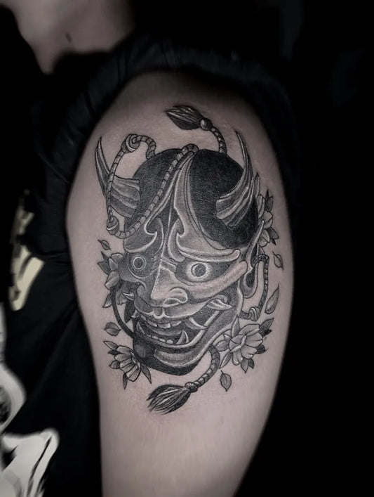 Medium Black and Grey Oni Mask with Flowers on Men Arm Tattoo by @blacksins_tattoos