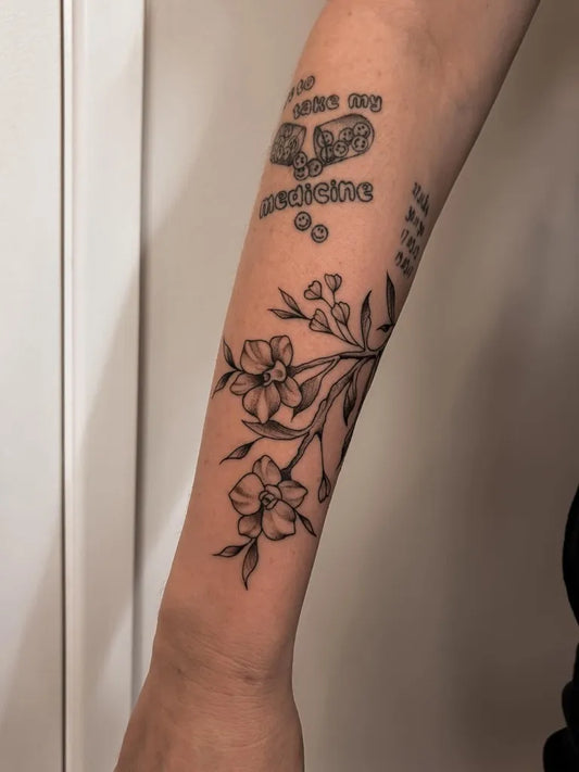 Medium Black and Grey Orchid Flowers Tattoo on Women Arm by @biancajade.tattoo