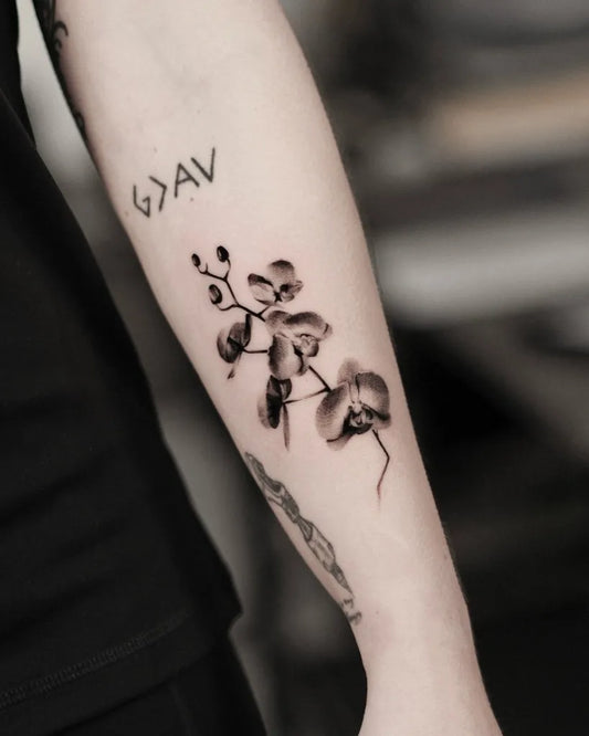 Medium Black and Grey Orchid Tattoo on Women Arm by @inkedbydaniel