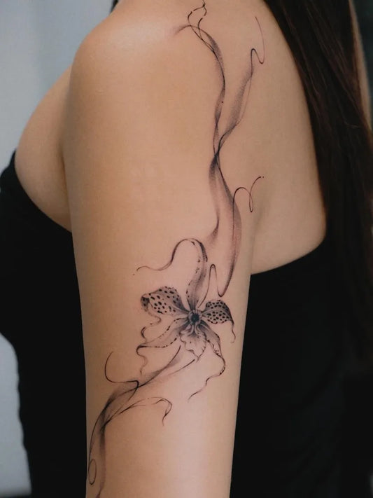 Medium Black and Grey Orchid Tattoo on Women Shoulder by @anna.tattoo.w