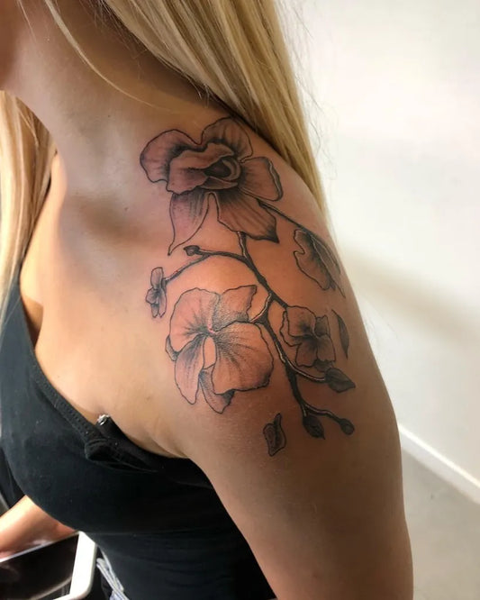 Medium Black and Grey Orchid Tattoo on Women Shoulder by @rico.inkz