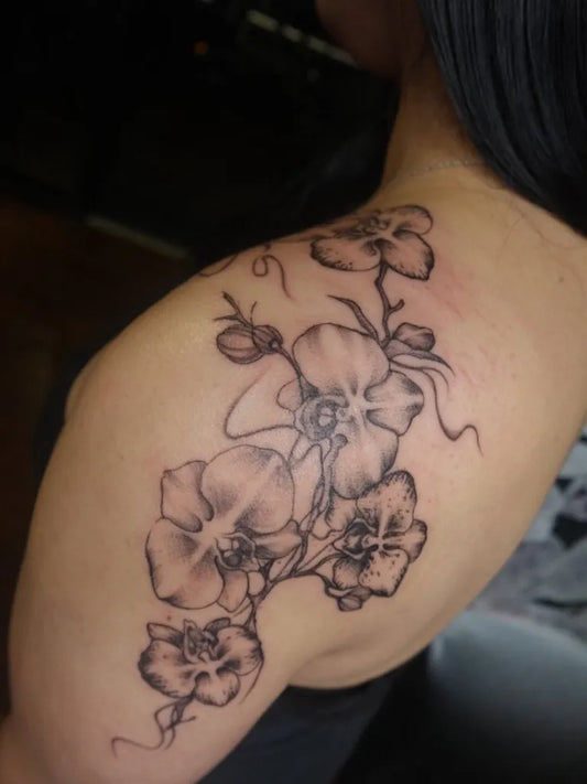 Medium Black and Grey Orchid Vine Tattoo on Women Shoulder by @blazed.inks