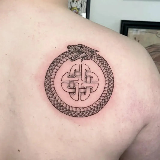Medium Black and Grey Ouroboros Celtic Knot Tattoo on Men Shoulder by @bythebrooke_tattoo
