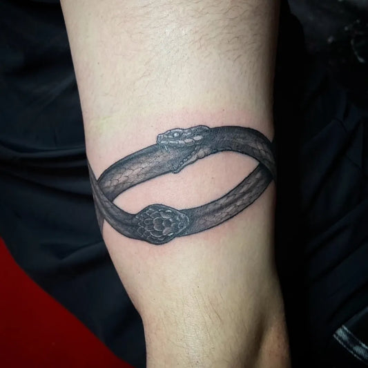 Medium Black and Grey Ouroboros Tattoo on Men Arm by @ajito.osaka.tattoo