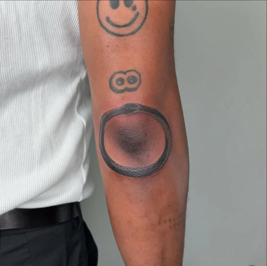 Medium Black and Grey Ouroboros Tattoo on Men Arm by @jd.tattooer