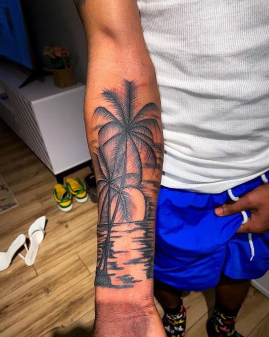Medium Black and Grey Palm Tree Sunset Reflection Tattoo on Men Arm by @tarneytattoos