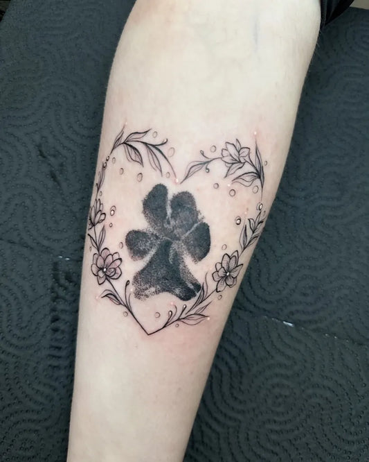 Medium Black and Grey Paw Print Heart Flowers Tattoo on Women Forearm by @pocotattooleeds