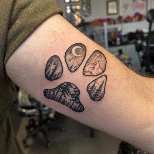 Medium Black and Grey Paw Print with Mountains and Trees Tattoo on Men Arm by @fettey.inks
