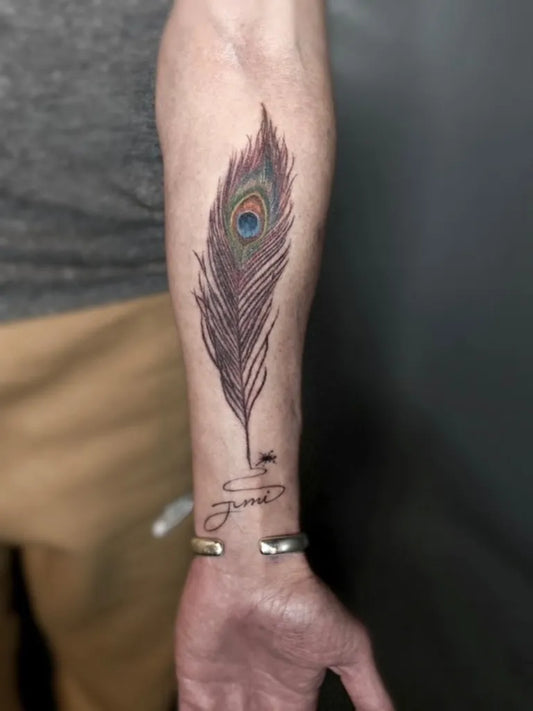 Medium Black and Grey Peacock Feather with Script Tattoo on Men Arm by @jmiart