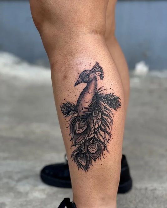 Medium Black and Grey Peacock Tattoo on Women Thigh by @temptink_tattoo_delhi
