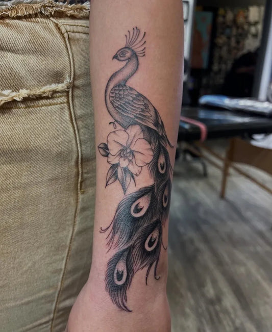 Medium Black and Grey Peacock and Orchid Tattoo on Women Arm by @kein_tattoo