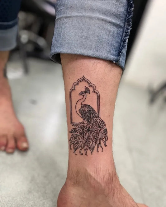 Medium Black and Grey Peacock in Arch Tattoo on Men Leg by @lakshbutiya_rjtattoosindia_