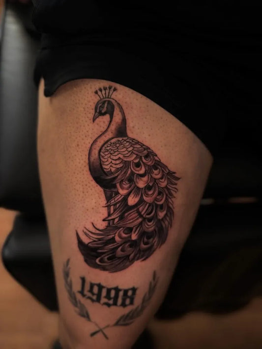 Medium Black and Grey Peacock with Laurel Banner Tattoo on Men Thigh by @831ink.addiction_