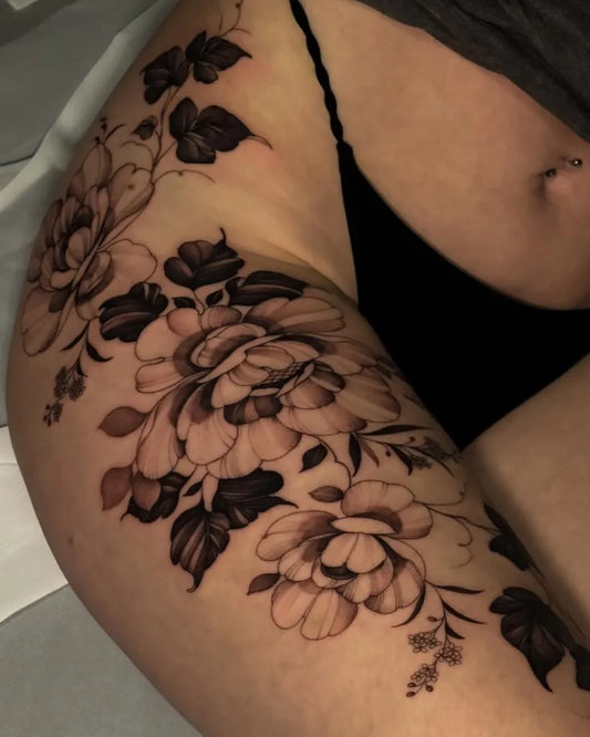 Medium Black and Grey Peonies and Leaves Tattoo on Women Hip by @victoria.bischof.ttt
