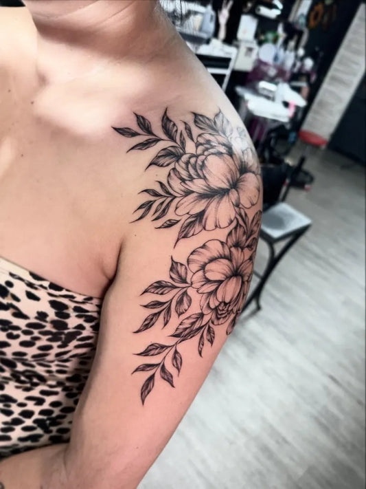 Medium Black and Grey Peony Flowers and Leaves Tattoo on Women Shoulder by @emilycolgantattoos
