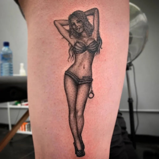 Medium Black and Grey Pin Up Girl with Handcuffs Tattoo on Women Thigh by @ta2istguy
