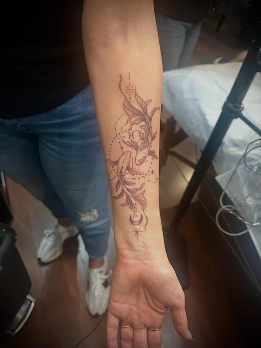 Medium Black and Grey Pisces Flowers Tattoo on Women Wrist by @monica_inks_