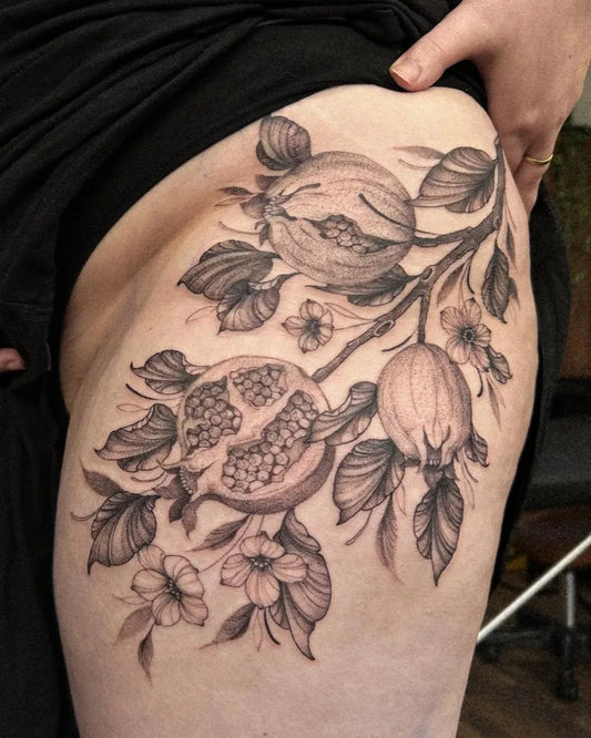 Medium Black and Grey Pomegranate and Flowers Tattoo on Women Hip by @emi1yelizabeth