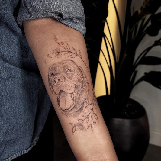 Medium Black and Grey Portrait Flowers Dog Tattoo on Women Arm by @iguana_tattoo_ch