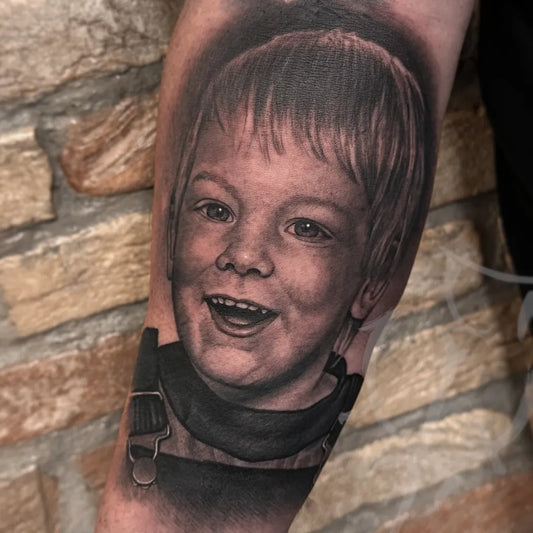 Medium Black and Grey Portrait of Young Boy in Overalls Family Tattoo on Men Arm by @felipetorrestattoo