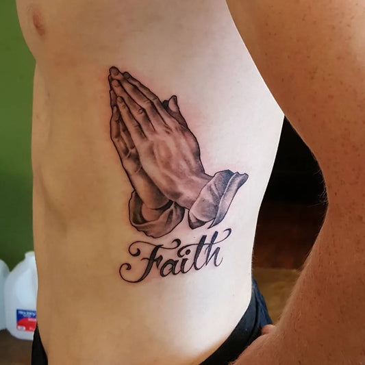 Medium Black and Grey Praying Hands Faith Tattoo on Men Rib by @ripley_tattoo