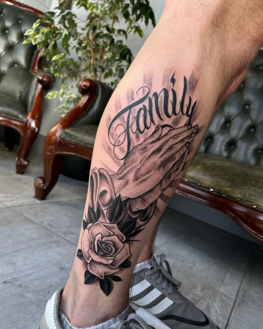 Medium Black and Grey Praying Hands Family Rose Tattoo on Men Leg by @not_dead_yet_tattoos