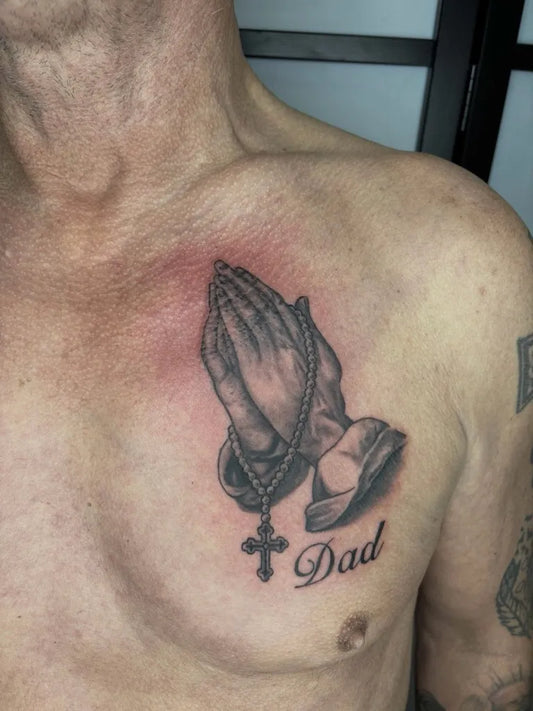 Medium Black and Grey Praying Hands Rosary and Cross Tattoo on Men Chest by @twoheartstattoo