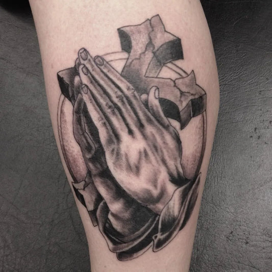 Medium Black and Grey Praying Hands and Broken Cross Tattoo on Men Leg by @vinniestones