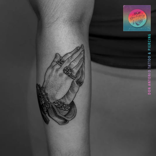 Medium Black and Grey Praying Hands with Bracelets Tattoo on Men Arm by @da.tattoo