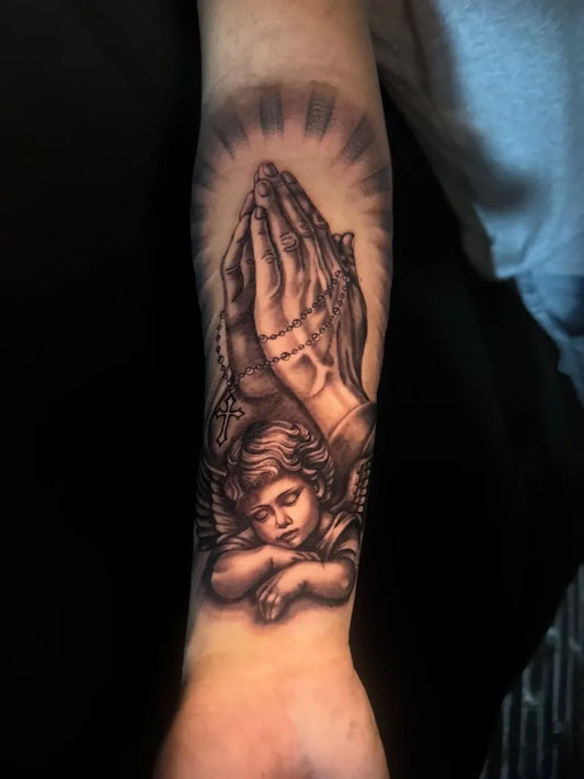Medium Black and Grey Praying Hands with Cherub Tattoo on Men Arm by @sergio.tat2s