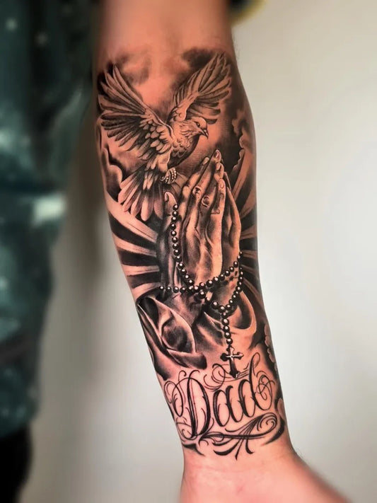 Medium Black and Grey Praying Hands with Dove and Dad Script Tattoo on Men Arm by @sophiecowantattoo