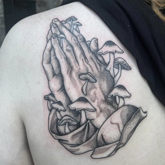 Medium Black and Grey Praying Hands with Mushrooms Tattoo on Women Shoulder by @christen.tattoo