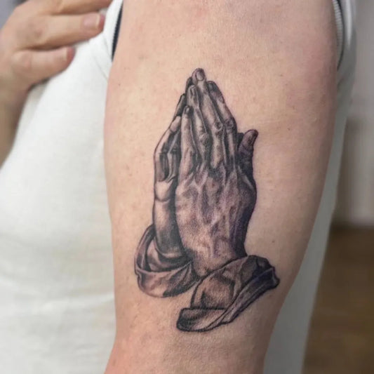 Medium Black and Grey Praying Hands with Rosary Tattoo on Women Arm by @jennybs_tattoo_goettingen