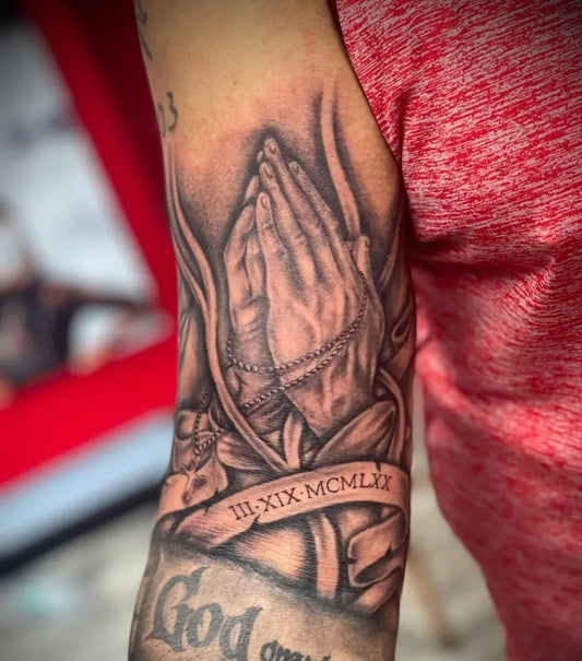Medium Black and Grey Praying Hands with Rosary and Banner Tattoo on Men Arm by @tattarot_ink