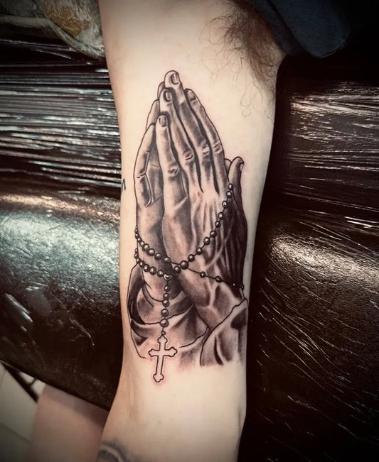 Medium Black and Grey Praying Hands with Rosary and Cross Tattoo on Men Arm by @skinartderry
