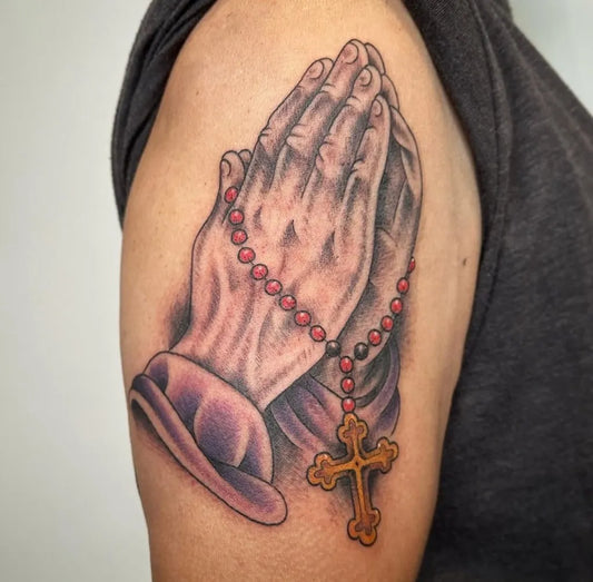 Medium Black and Grey Praying Hands with Rosary and Cross Tattoo on Men Upper Arm by @thebellrosetattoo