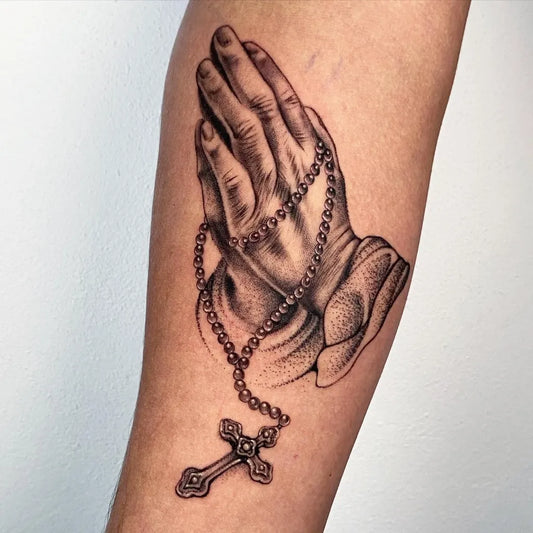 Medium Black and Grey Praying Hands with Rosary and Cross Tattoo on Women Arm by @cuevas_____