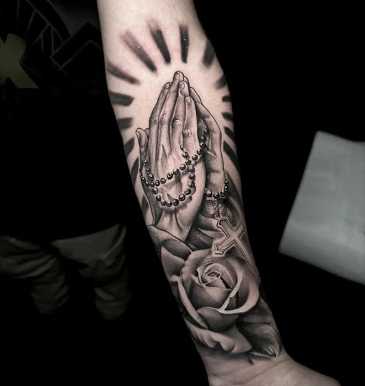 Medium Black and Grey Praying Hands with Rosary and Rose Tattoo on Men Arm by @rawb_tattoos