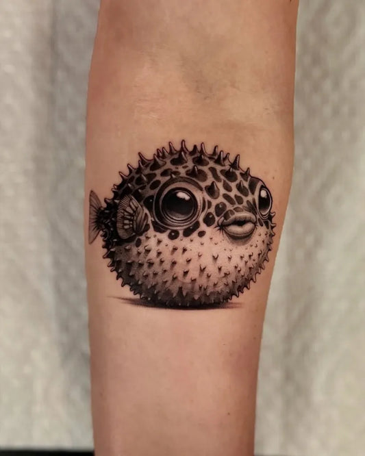 Medium Black and Grey Pufferfish Tattoo on Women Forearm by @theartoftattooingofficial