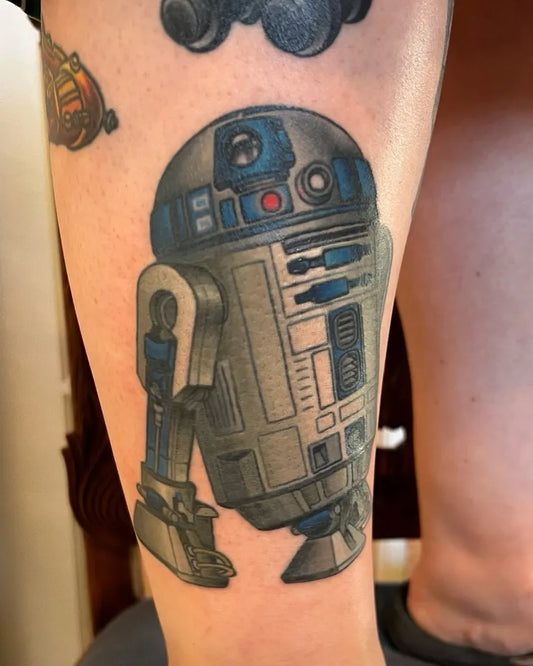 Medium Black and Grey R2 D2 Star Wars Tattoo on Women Leg by @mikebiancoart