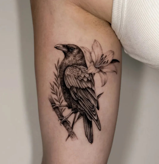 Medium Black and Grey Raven Lily Branch on Women Arm Tattoo by @nickyrose.tattoos