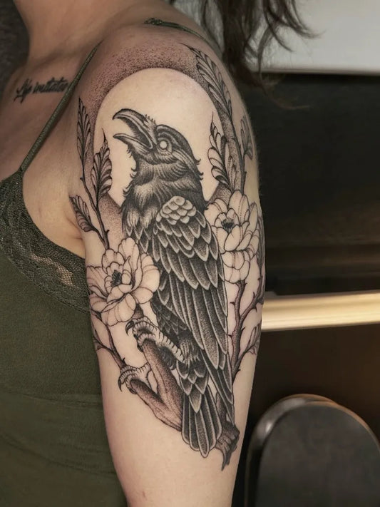 Medium Black and Grey Raven and Flowers on Women Shoulder Tattoo by @benjaminelitattoo
