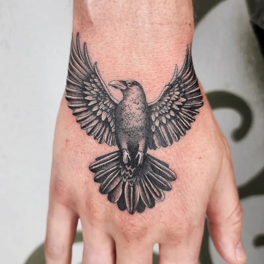 Medium Black and Grey Raven on Men Hand Tattoo by @lwoodstattoo