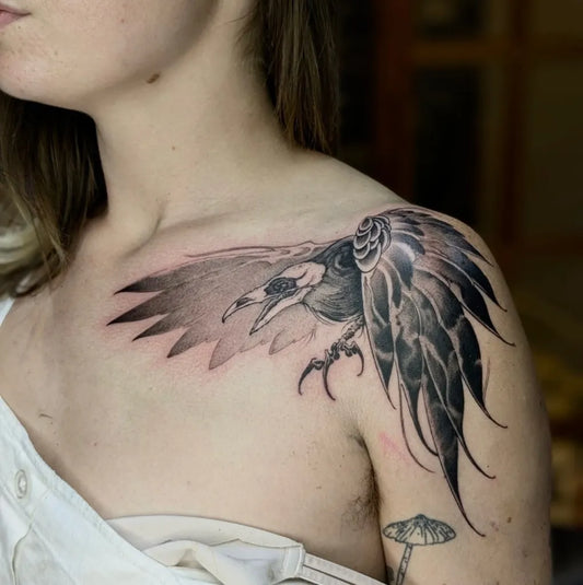 Medium Black and Grey Raven with Feathers on Women Shoulder Tattoo by @calcuttainktattoostudio