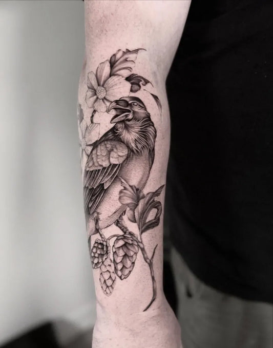Medium Black and Grey Raven with Flowers and Hops on Men Arm Tattoo by @bg.tattoos