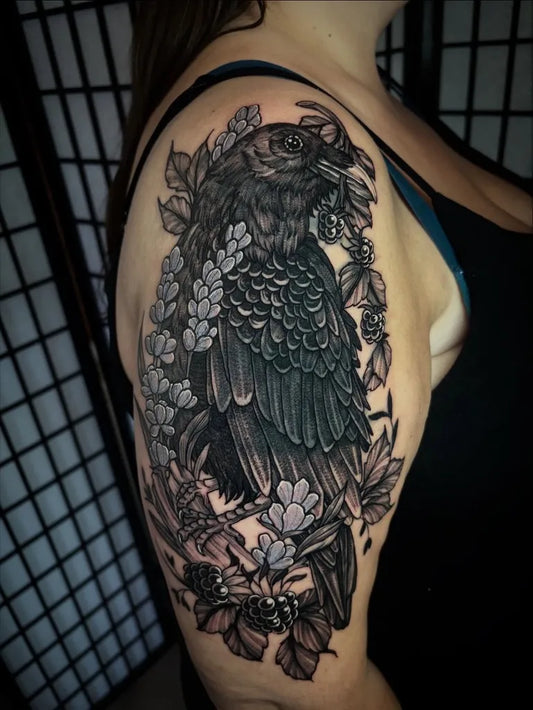 Medium Black and Grey Raven with Flowers and Leaves on Women Arm Tattoo by @bexpriesttattoos
