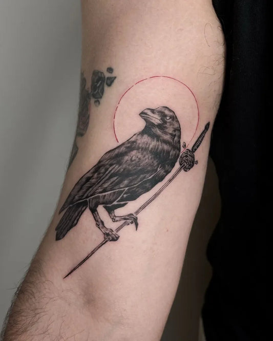 Medium Black and Grey Raven with Halo and Staff on Men Arm Tattoo by @raw_withlove