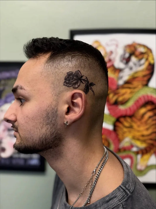 Medium Black and Grey Rose Tattoo on Men Head by @amourtattoo