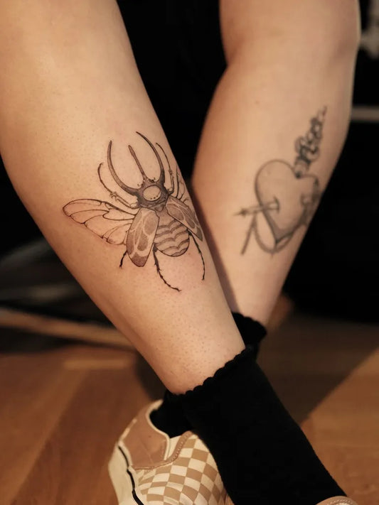Medium Black and Grey Sacred Heart Beetle Tattoo on Women Leg by @leh.ttt